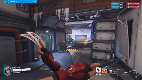 Overwatch 2 review: A woman holding ninja stars and tokens across her chest looks at a robot