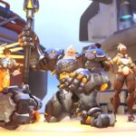 Overwatch 2 transfer skins: Mercy, Tracer, Reinhardt, Sojourn, and Brigitte standing in a row on a hangar.