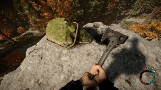 Best survival games: The player wields an axe, and is about to cut through a rope in Sons of the Forest